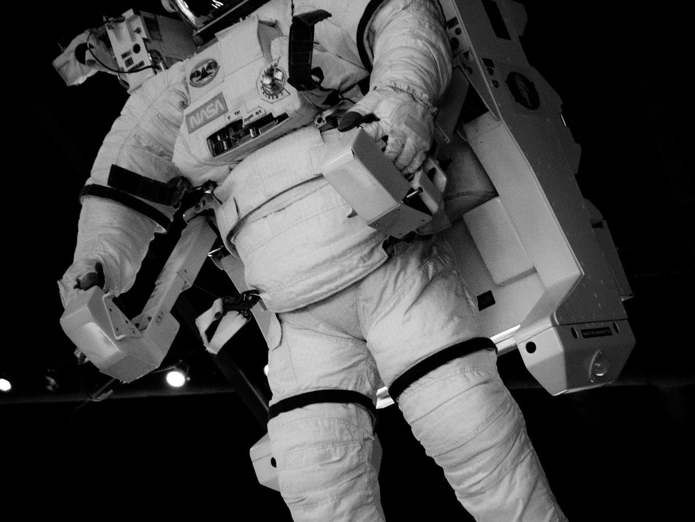 astronauts inside spacecraft control room zero gravity space suit