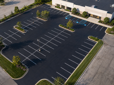 Fresh sealcoat being applied to a commercial parking lot in Central Ohio
