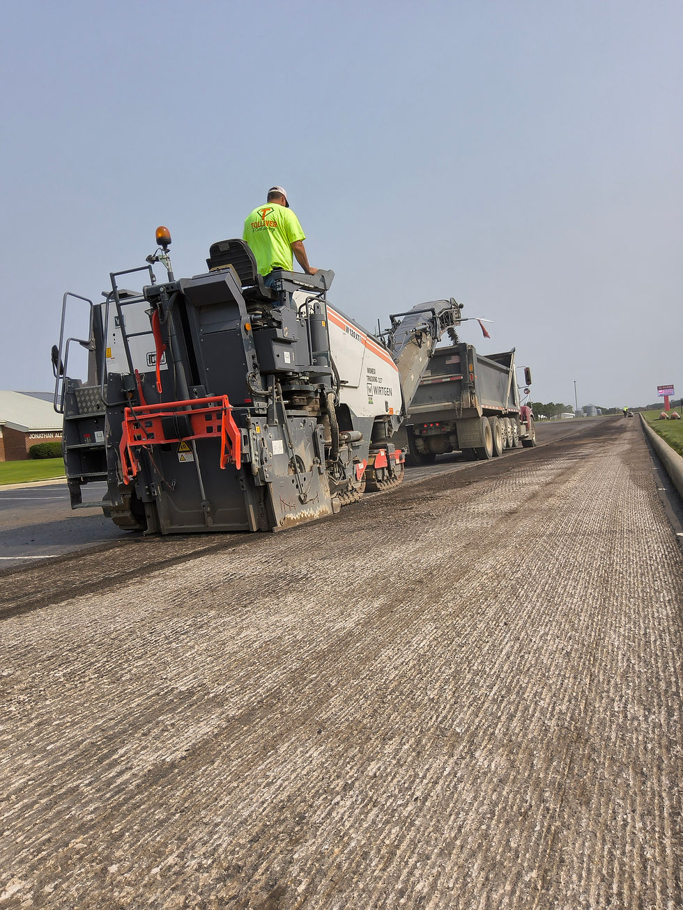 Asphalt crew compacting a hot mix patch