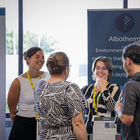 Attendees networking beside an Albotherm exhibition display at the Future Space anniversary event in Bristol.