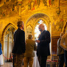 Guests talking beneath the ornate murals and stained-glass windows at Cardiff Castle during an Independents by Sodexo event.
