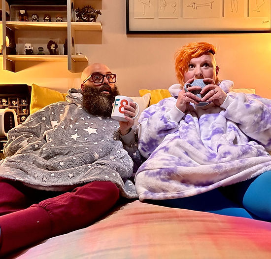 Couple Wearing Kuddly Hoodie Blanket on Sofa Gift Idea