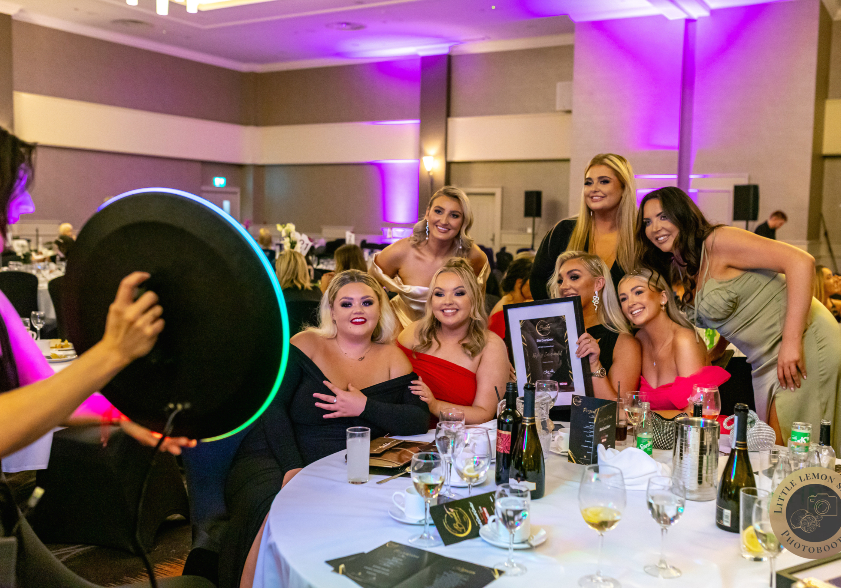 Roaming photo booth attendant photographing guests at a corporate gala