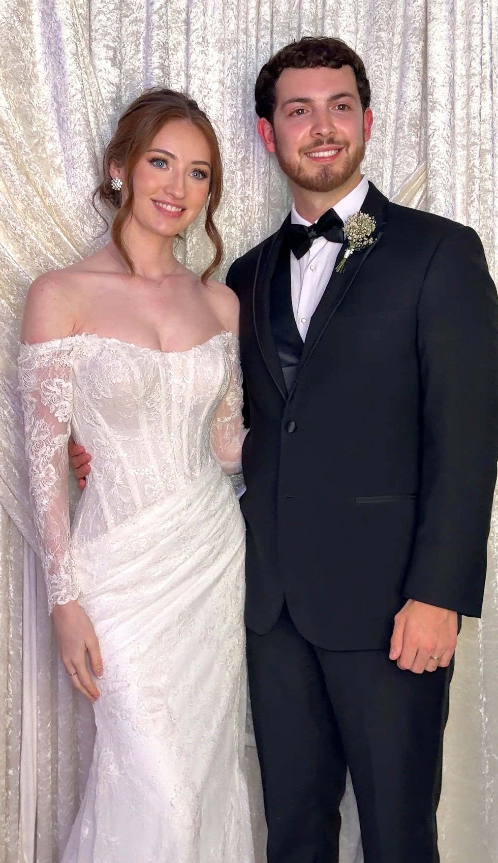 Husband and Wife posing in front of the Photo Booth at The preserve at canyon lake
