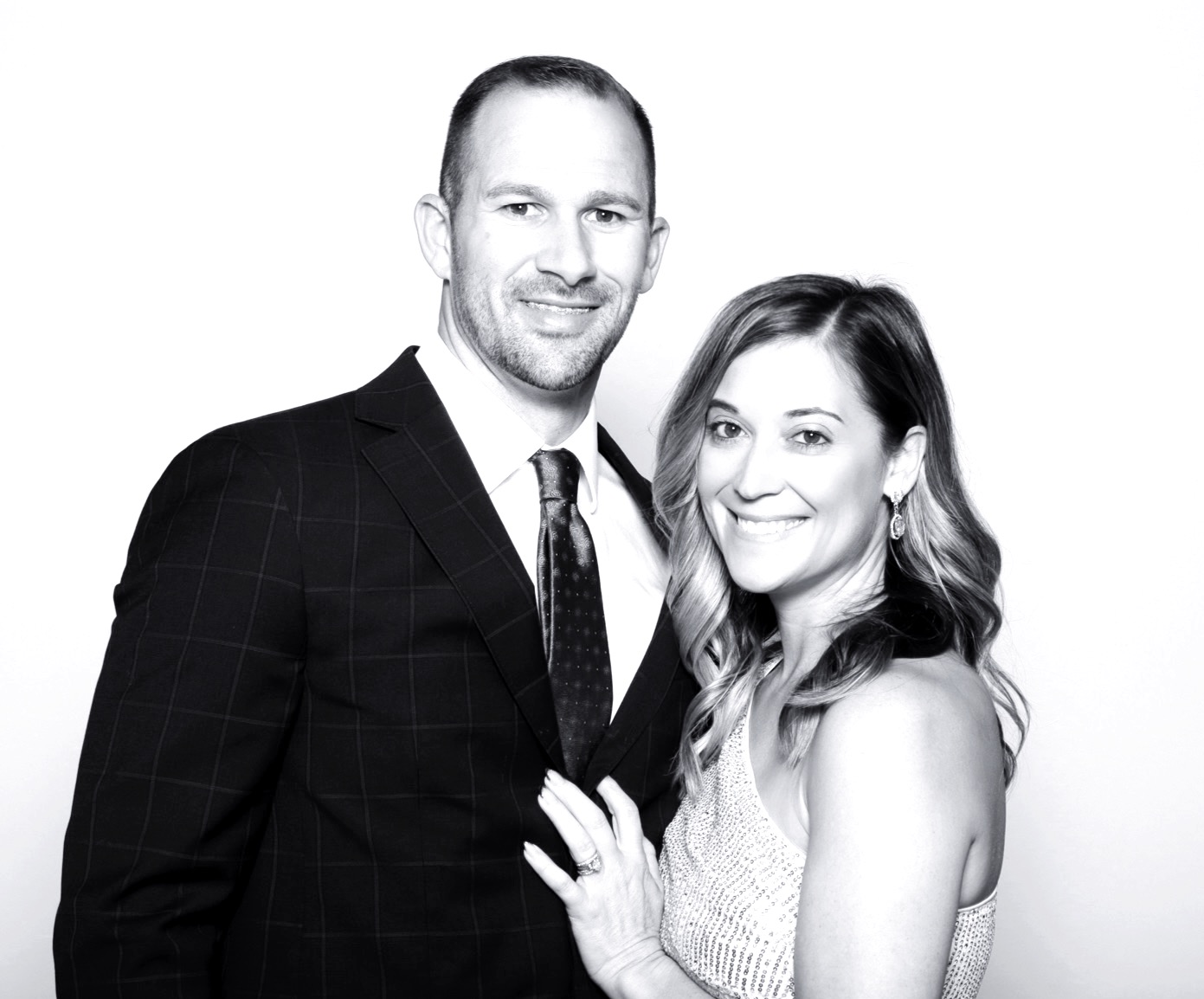 Couple posing in a black and white glam photo booth at a San Antonio event