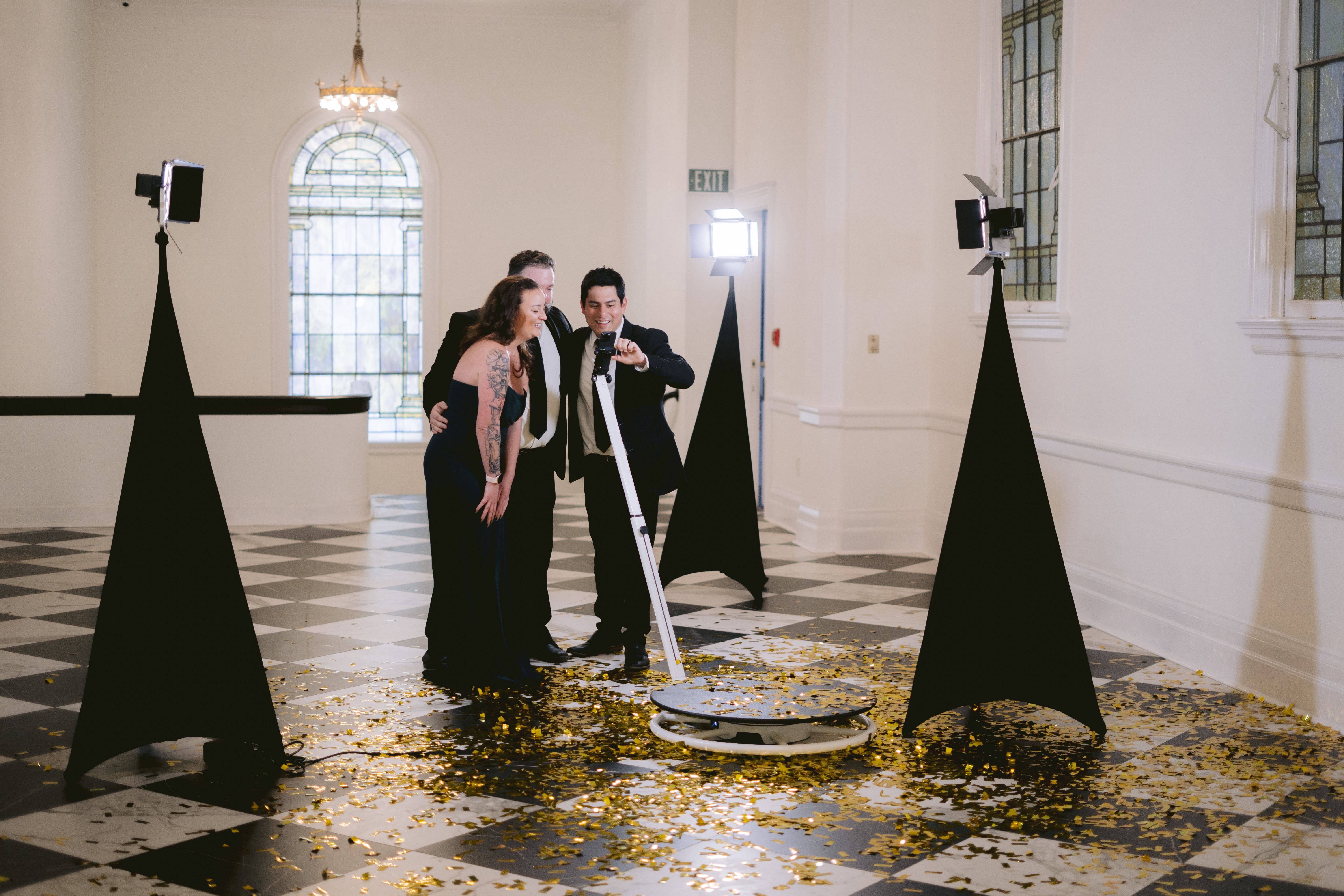 Guests filming slow motion video on a 360 video booth platform
