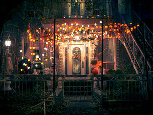a nighttime halloween decorated porch with glowing lights