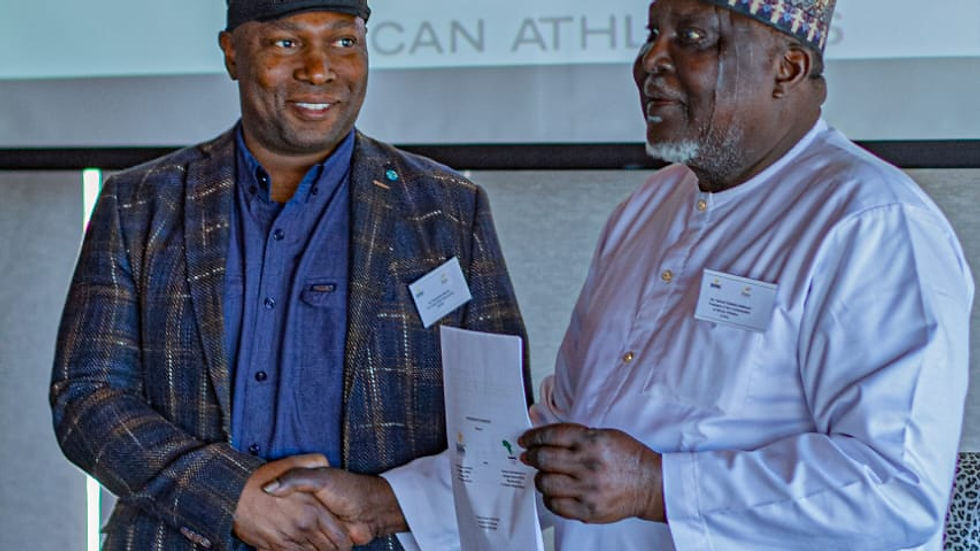 Confederation of African Athletics President Kalkaba and World Wide Scholarships CEO Munya Maraire shake hands at signing ceremony 
