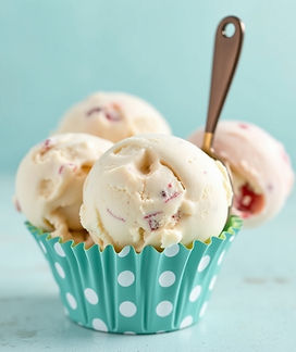 rounded ice cream scoops in a paper teal cup with polka dots.jpg