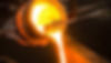 Eye-level view of molten metal being poured into a sand mold in a foundry.