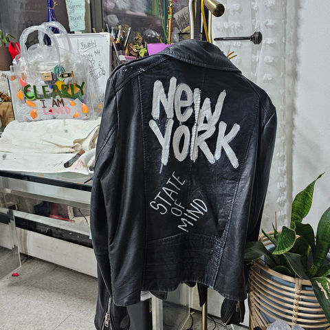 Black genuine leather jacket with zipper closure.