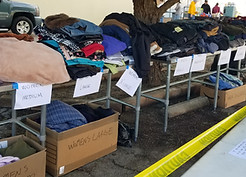 tables with clothing and blankets