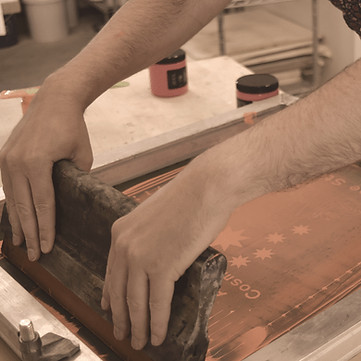 close up view of a person in the process of creating a screen print