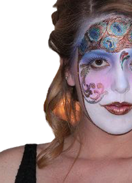 A pretty young girl has her face painted as though she is wearing a mardi-gras mask with peacock feathers across her forehead.