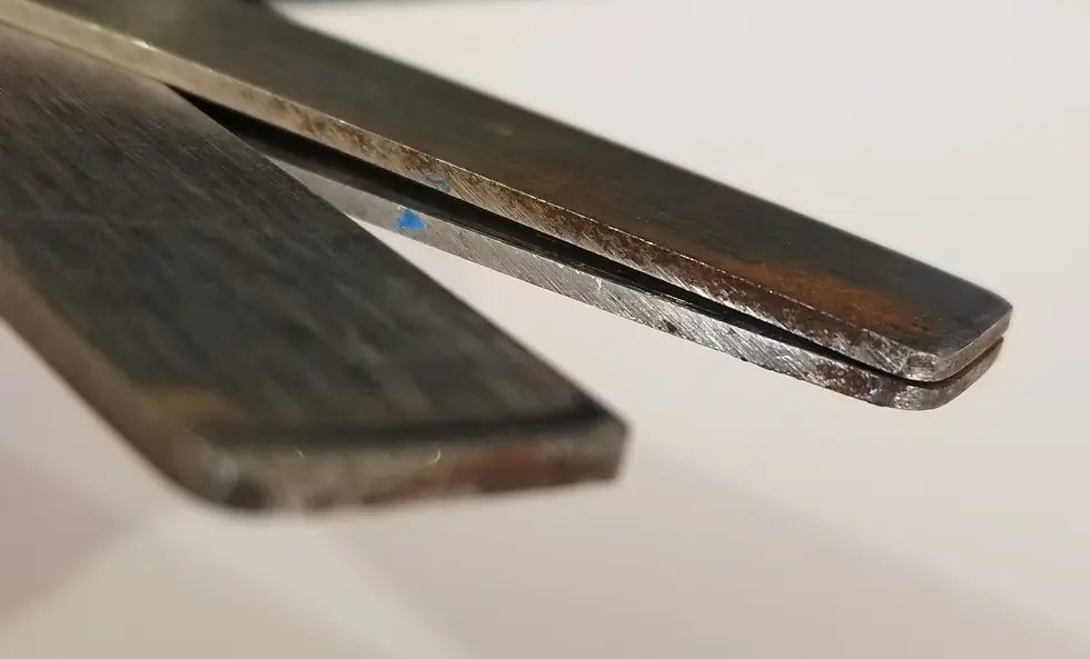 The tip of pattern shears show how one blade is a simple blade that cuts through a set of blades.