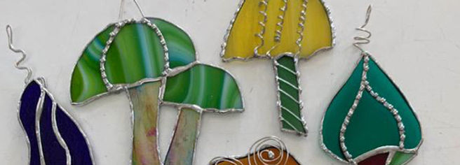 A close up view of stained glass mushrooms made out of colorful glass.