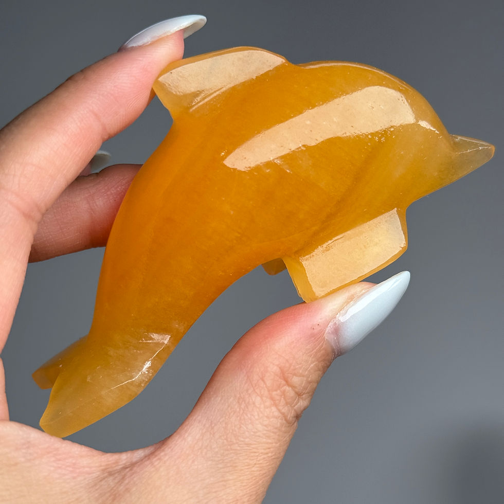 orange calcite dolphin crystal carving