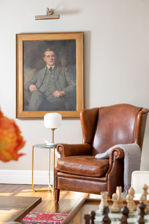 Leather chair sitting room portrait detail-min