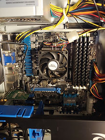 Blue gaming computer with fan and ram slots showing different colored wires
