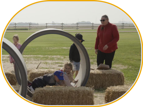 An instructor laughs as the children play.