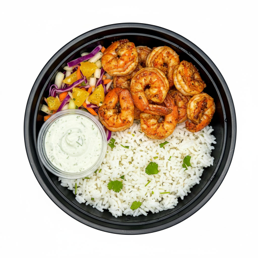 The LunaFit Fresh Smoky Shrimp Bowl Meal sits in a round black bowl filled with smoky, reddish-orange seasoned grilled shrimp over white rice, garnished with diced yellow and red peppers, and served with a small cup of creamy white dressing.
