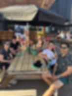 runners eating pizza at picnic table
