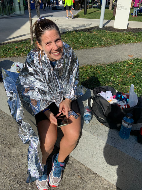 happy marathon runner in foil blanket