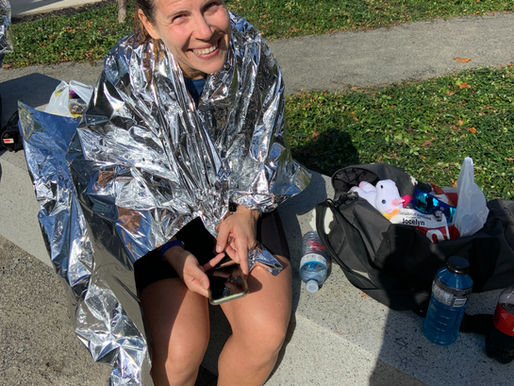 happy marathon runner in foil blanket
