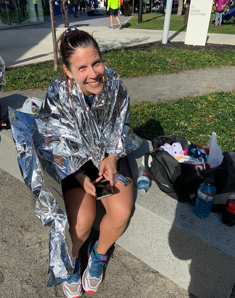 happy marathon runner in foil blanket