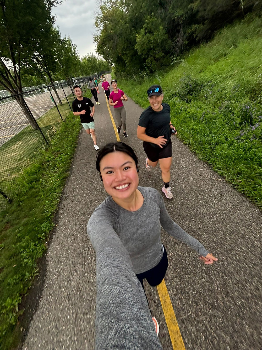 smiling runners on pathway