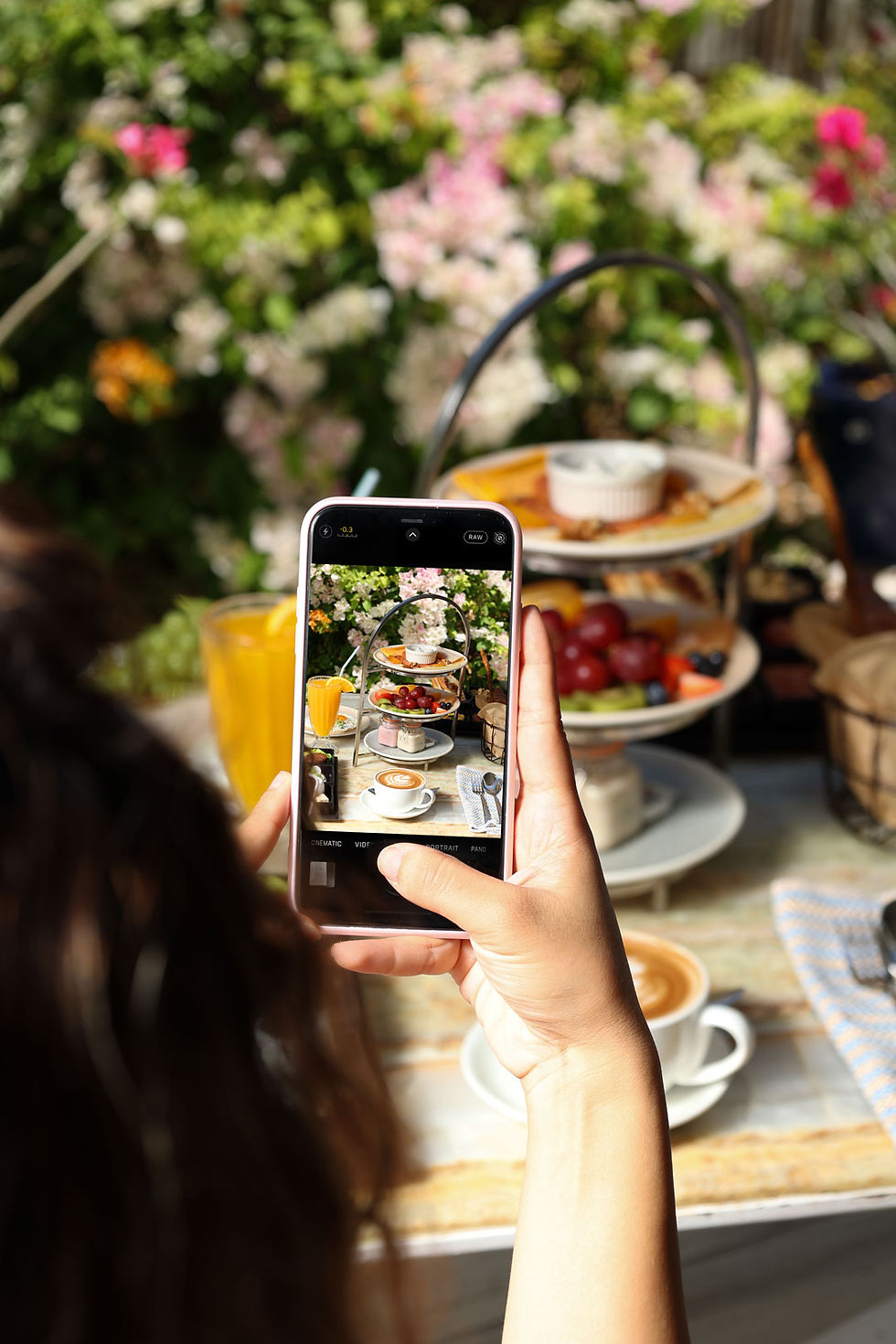 A girl taking a picture using her mobile phone of the Sansation Breakfast