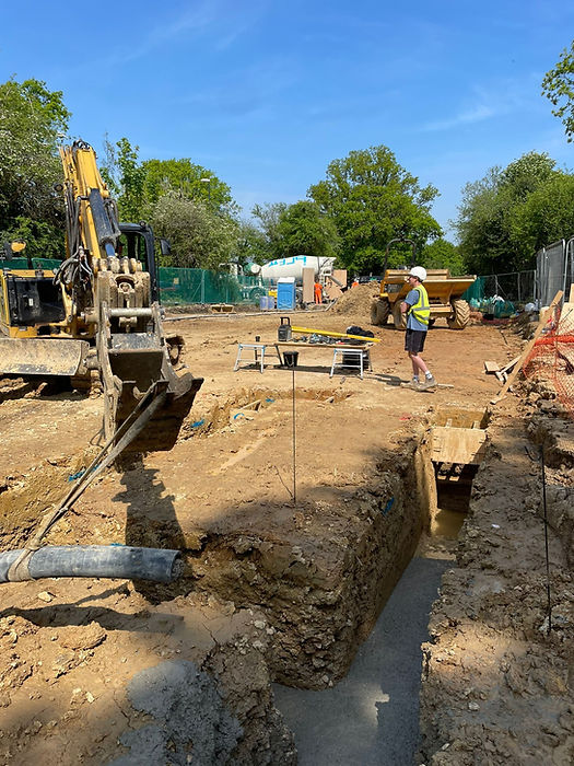 Professionals excavating a trench at an active construction site in Bexleyheath.