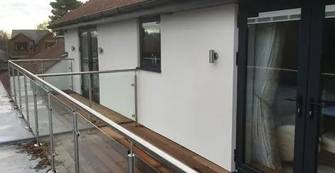 A balcony of a large white home