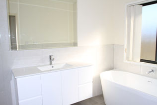 Full bathroom renovation with brightening features.