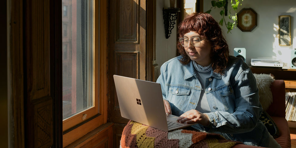 Woman looking at laptop with neutral face