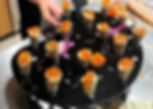 Overhead view of artful canapés arranged on a marble serving tray.