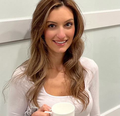 Boston Sleep Consultant- Stellina Ferri holding a cup of coffee