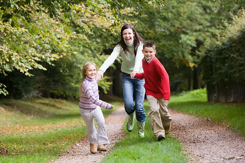 mother-and-children-running-along-woodla