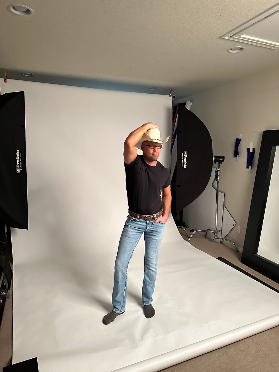 Adam Bailey, the lively host of Coffee with Gays™, wearing a cowboy hat during a photoshoot in Austin, Texas.