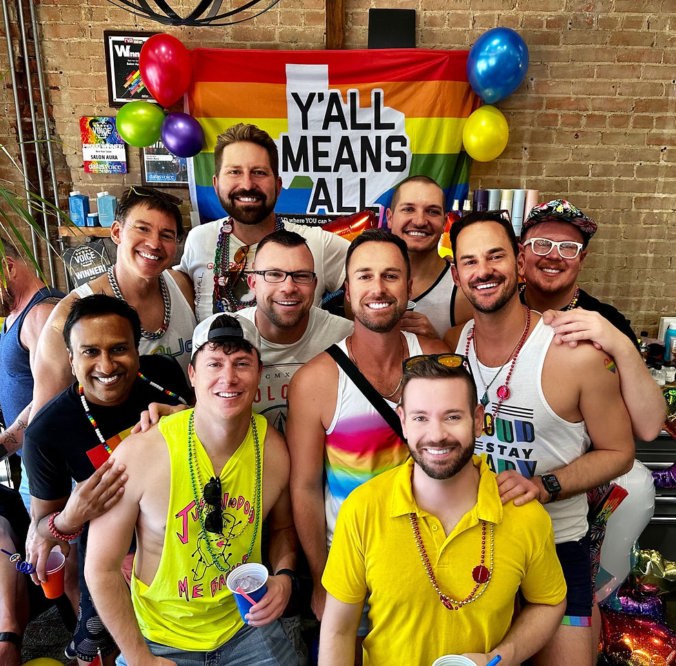 Group of friends showing support during Dallas Pride in front of a 'Y'all Means All' flag