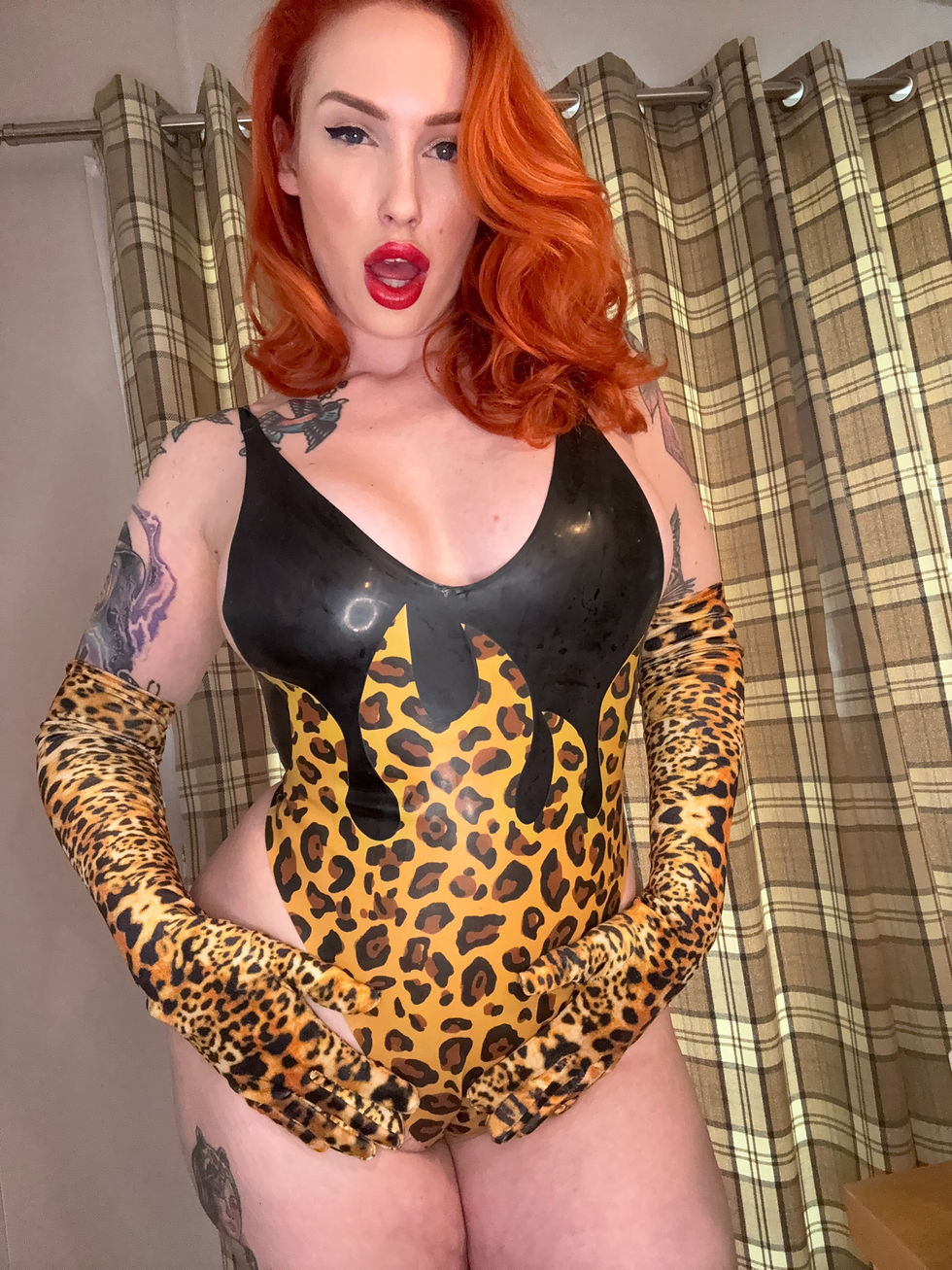 Mistress Prin in a leopard print latex bodysuit.