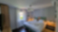 Bedroom 2 of A-84 vacation home with double bed, reading lights, and window view