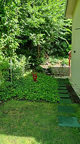 A-84 vacation home side garden with stone path and two red rabbit statues