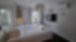 Bedroom 4 of A-84 vacation home with king-sized bed, wall-mounted TV, and air conditioner