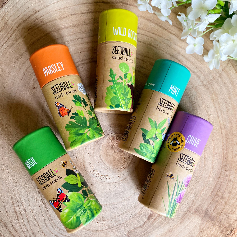 5 tubes of herb seedballs lying on a wooden table