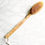 Thumbnail: Long wooden bath brush lying on a bathroom counter