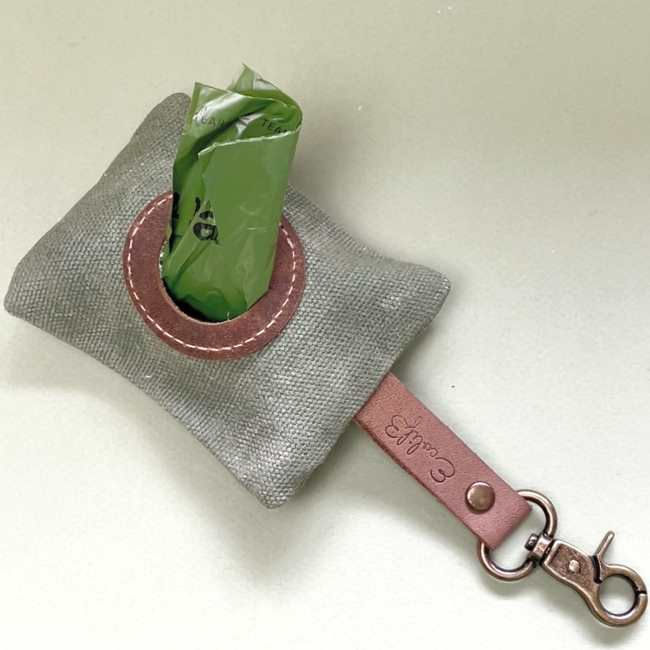 Thumbnail: Canvas dog poo bag holder, with a roll of biodegradable bags inside