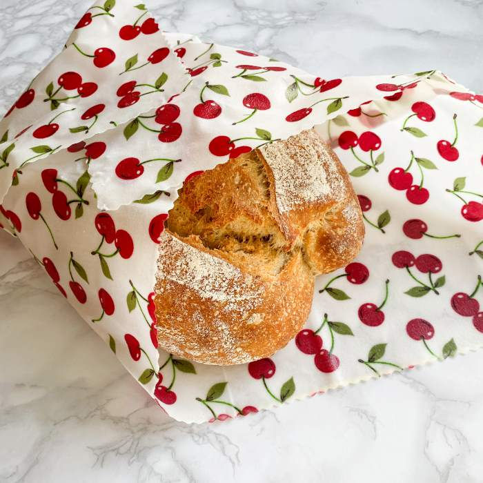 Thumbnail: Loaf of bread wrapped in an extra large beeswax food wrap in a cherry print