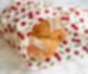 Large loaf of bread wrapped in a cherry-patterned beeswax wrap