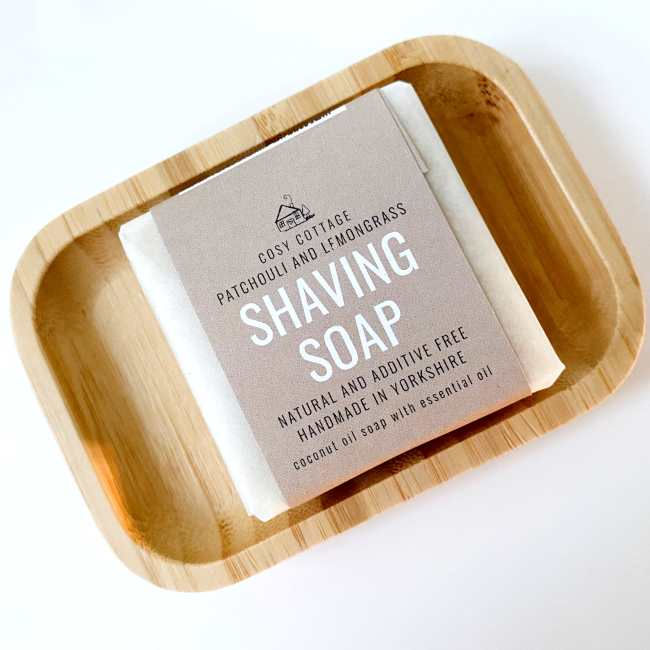 Thumbnail: Bar of handmade natural shaving soap resting on a wooden soap dish on a bathroom counter